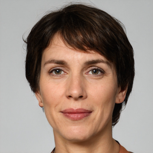 Joyful white adult female with short  brown hair and grey eyes