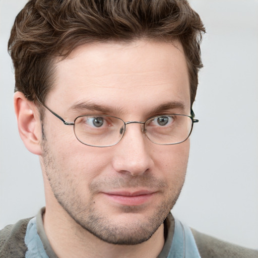 Joyful white young-adult male with short  brown hair and blue eyes