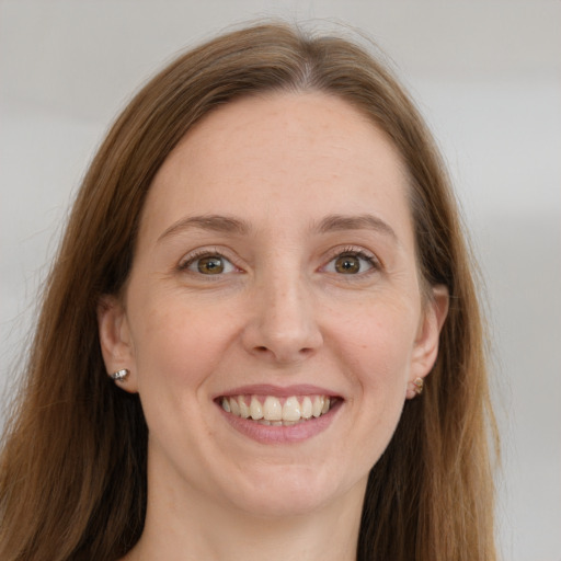 Joyful white young-adult female with long  brown hair and grey eyes