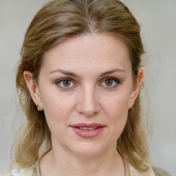 Joyful white young-adult female with medium  brown hair and green eyes