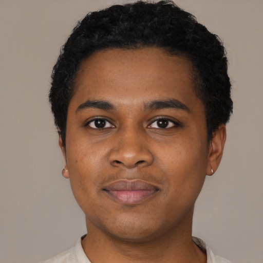 Joyful black young-adult male with short  black hair and brown eyes