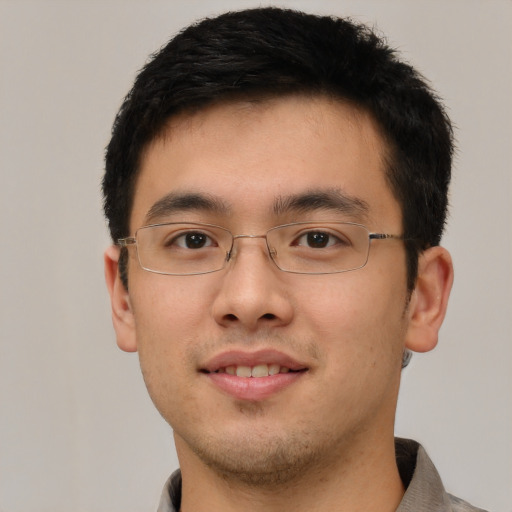 Joyful asian young-adult male with short  brown hair and brown eyes