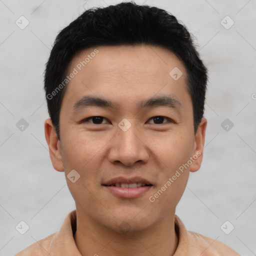 Joyful asian young-adult male with short  black hair and brown eyes