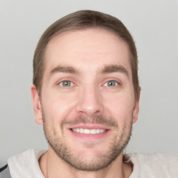 Joyful white young-adult male with short  brown hair and grey eyes