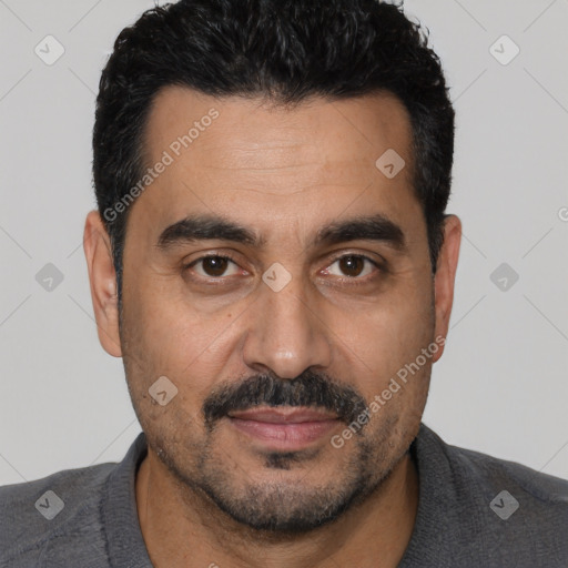 Joyful white adult male with short  black hair and brown eyes