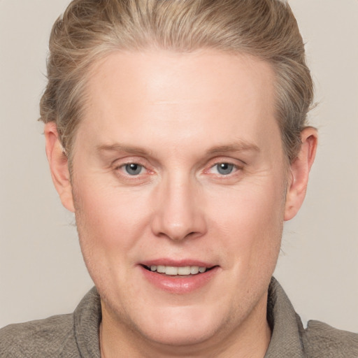 Joyful white adult male with short  brown hair and blue eyes