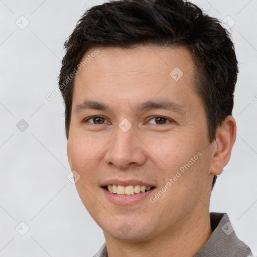 Joyful white adult male with short  brown hair and brown eyes