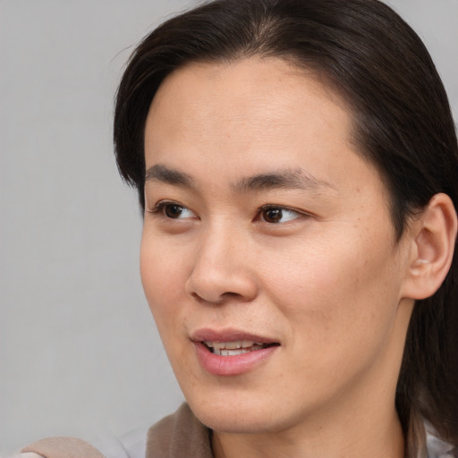 Joyful white young-adult female with medium  brown hair and brown eyes