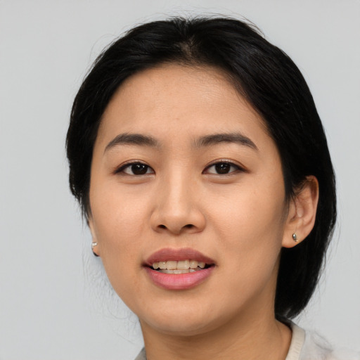 Joyful asian young-adult female with medium  black hair and brown eyes