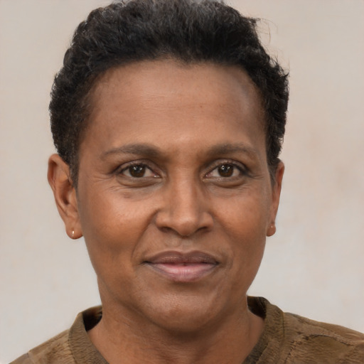 Joyful black adult female with short  brown hair and brown eyes