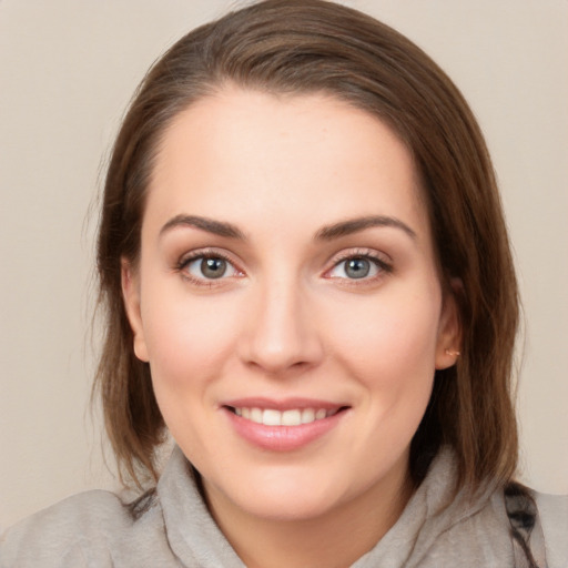 Joyful white young-adult female with medium  brown hair and blue eyes