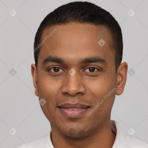 Joyful black young-adult male with short  black hair and brown eyes