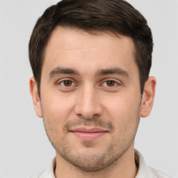 Joyful white young-adult male with short  brown hair and brown eyes