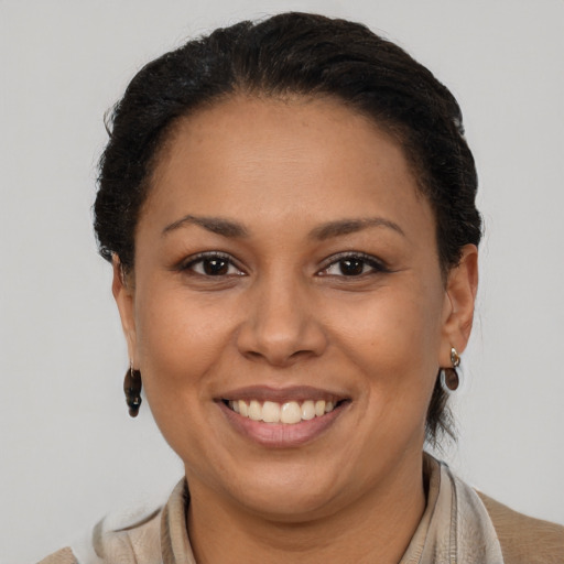 Joyful latino adult female with short  brown hair and brown eyes