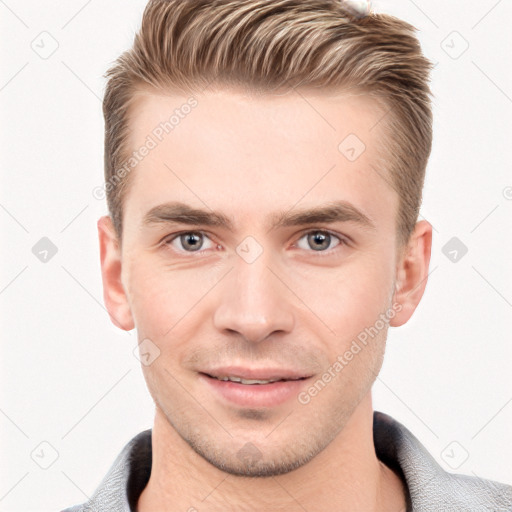 Joyful white young-adult male with short  brown hair and grey eyes