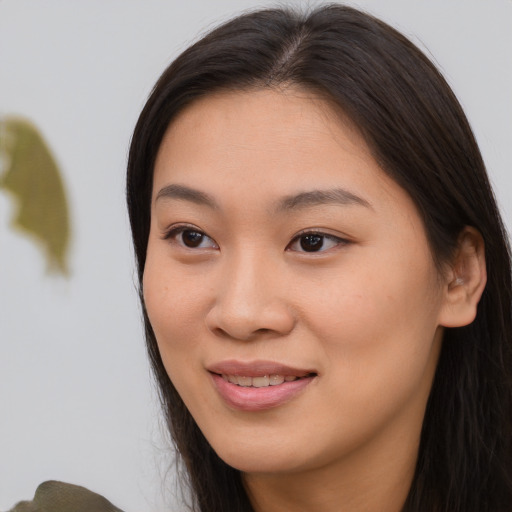 Joyful asian young-adult female with long  brown hair and brown eyes