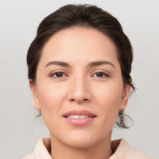 Joyful white young-adult female with medium  brown hair and brown eyes