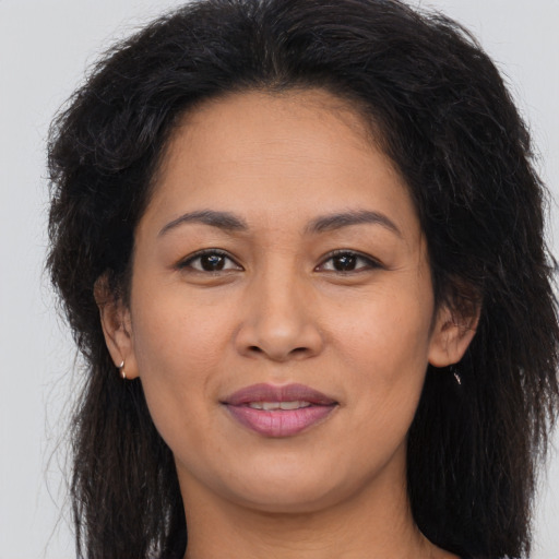 Joyful asian young-adult female with long  brown hair and brown eyes