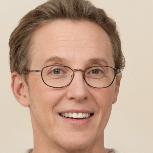 Joyful white adult male with short  brown hair and grey eyes