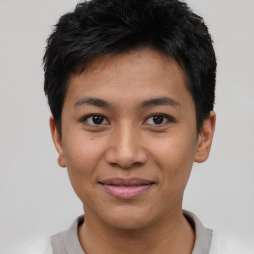 Joyful asian young-adult male with short  black hair and brown eyes