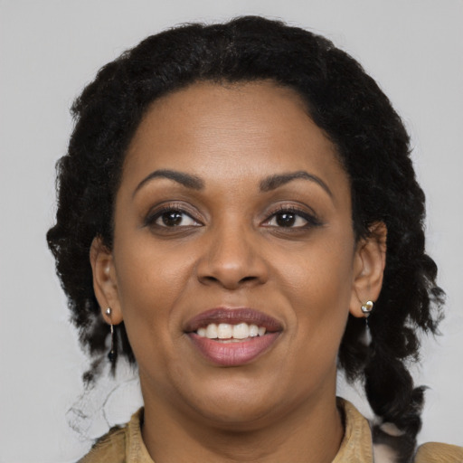 Joyful latino adult female with long  brown hair and brown eyes