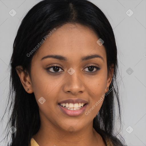 Joyful black young-adult female with long  black hair and brown eyes