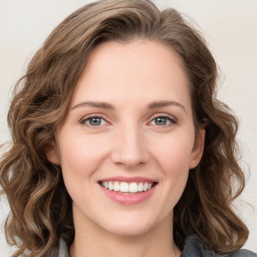 Joyful white young-adult female with long  brown hair and green eyes