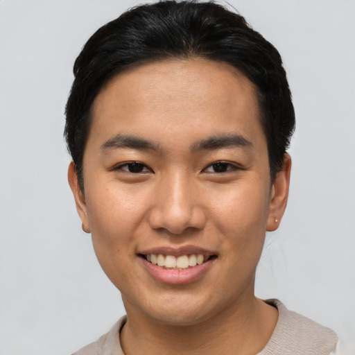 Joyful asian young-adult male with short  brown hair and brown eyes