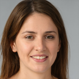 Joyful white young-adult female with long  brown hair and green eyes