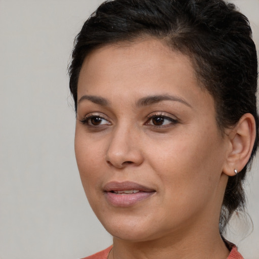 Joyful black young-adult female with medium  brown hair and brown eyes