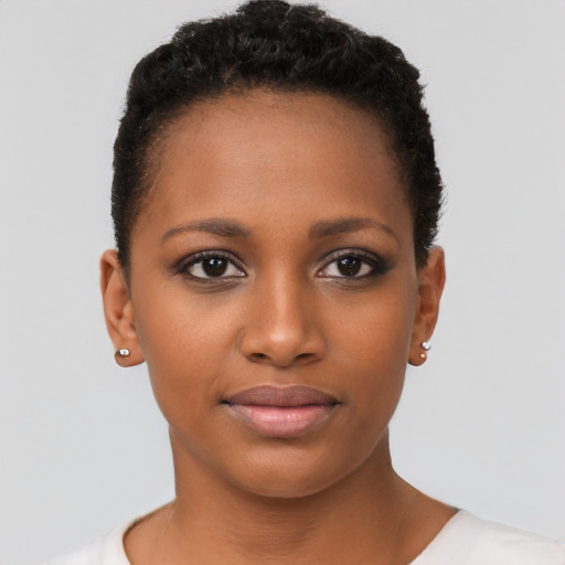 Joyful black young-adult female with short  brown hair and brown eyes