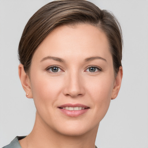 Joyful white young-adult female with short  brown hair and grey eyes