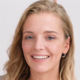 Joyful white young-adult female with long  brown hair and blue eyes