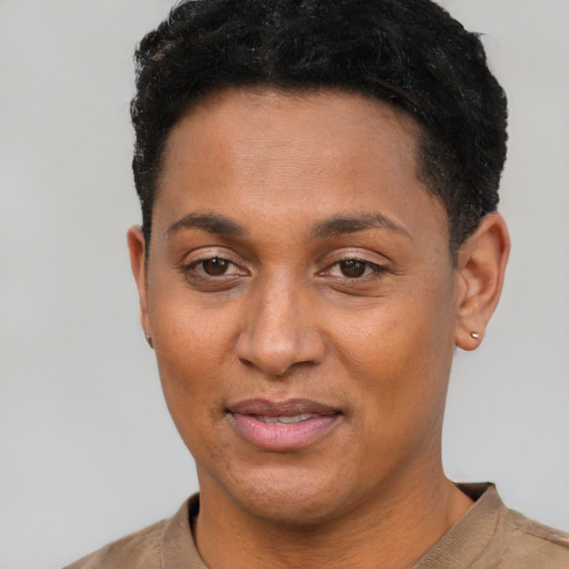 Joyful black young-adult female with short  black hair and brown eyes