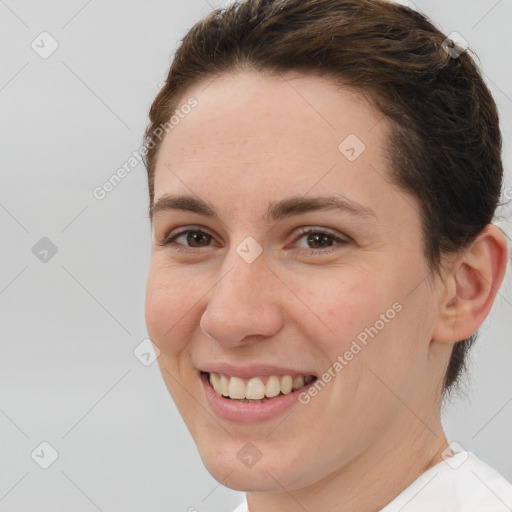 Joyful white young-adult female with short  brown hair and brown eyes