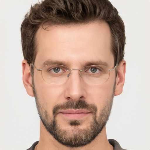 Joyful white adult male with short  brown hair and grey eyes