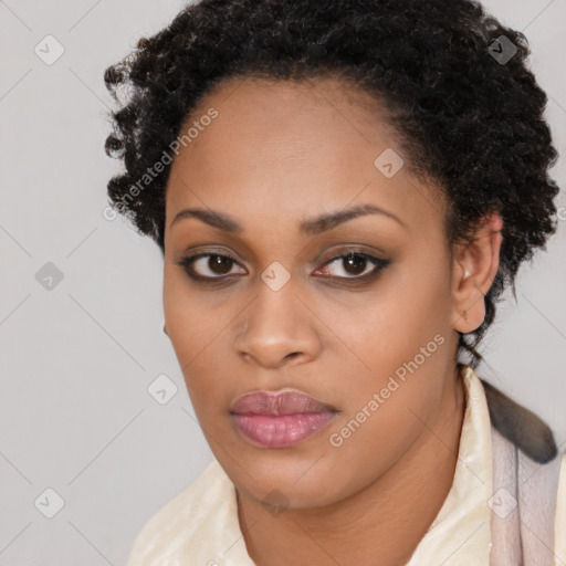 Joyful black young-adult female with short  brown hair and brown eyes