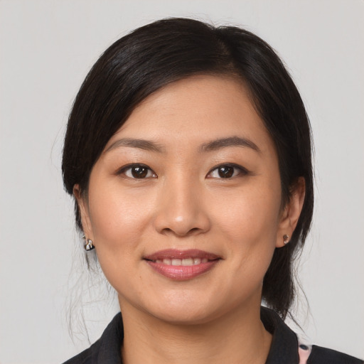 Joyful asian young-adult female with medium  black hair and brown eyes