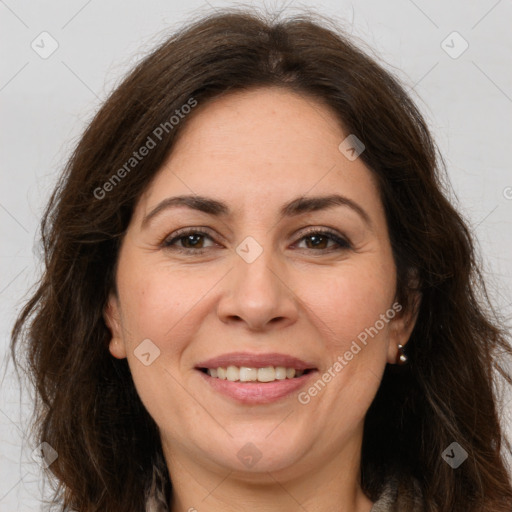 Joyful white adult female with long  brown hair and brown eyes