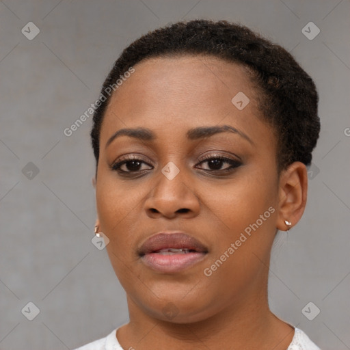 Joyful black young-adult female with short  brown hair and brown eyes