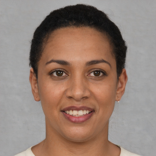 Joyful white young-adult female with short  brown hair and brown eyes