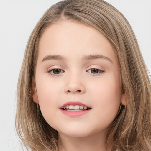 Joyful white child female with long  brown hair and brown eyes