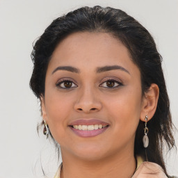 Joyful latino young-adult female with long  brown hair and brown eyes