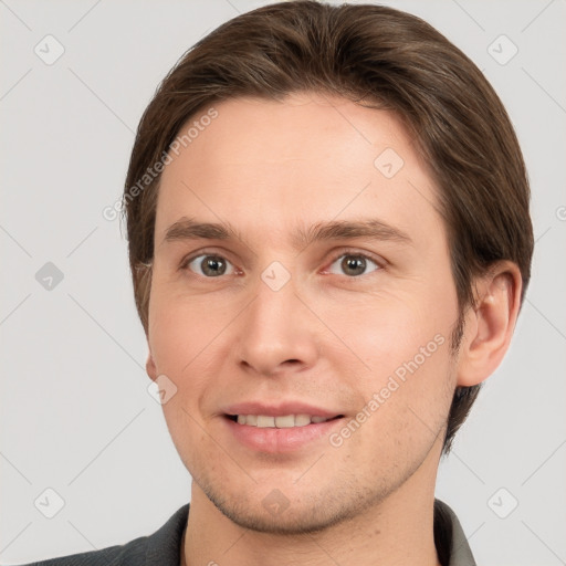 Joyful white young-adult male with short  brown hair and grey eyes