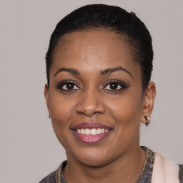 Joyful latino young-adult female with short  black hair and brown eyes
