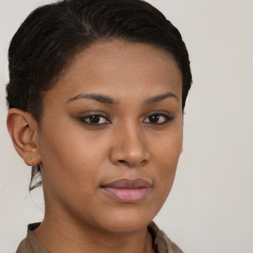 Joyful latino young-adult female with short  brown hair and brown eyes