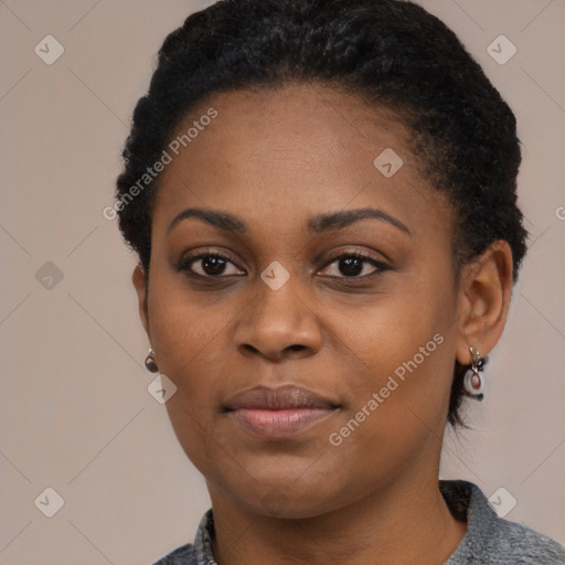 Joyful black young-adult female with short  black hair and brown eyes