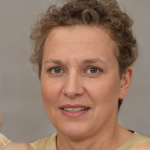 Joyful white adult female with short  brown hair and brown eyes