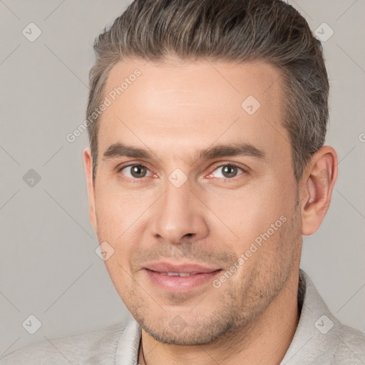 Joyful white adult male with short  brown hair and brown eyes