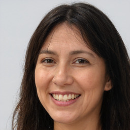 Joyful white adult female with long  brown hair and brown eyes